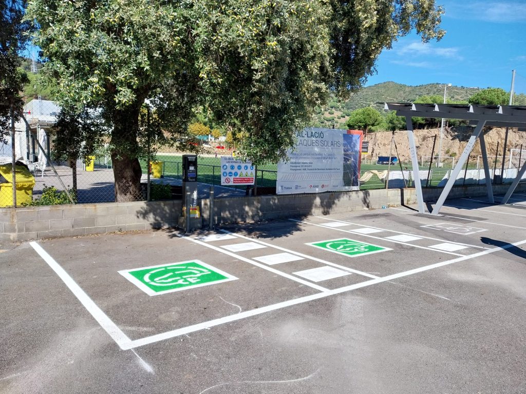 Espacio para recarga de vehículos eléctricos en parquing municipal en Tiana. Impulso Solar tambien instaló una marquesina con paneles solares la generación de energías limpias.